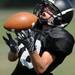 A Dexter High School football player looks to catch the ball during practice at the school on Friday, August 16, 2013. Melanie Maxwell | AnnArbor.com